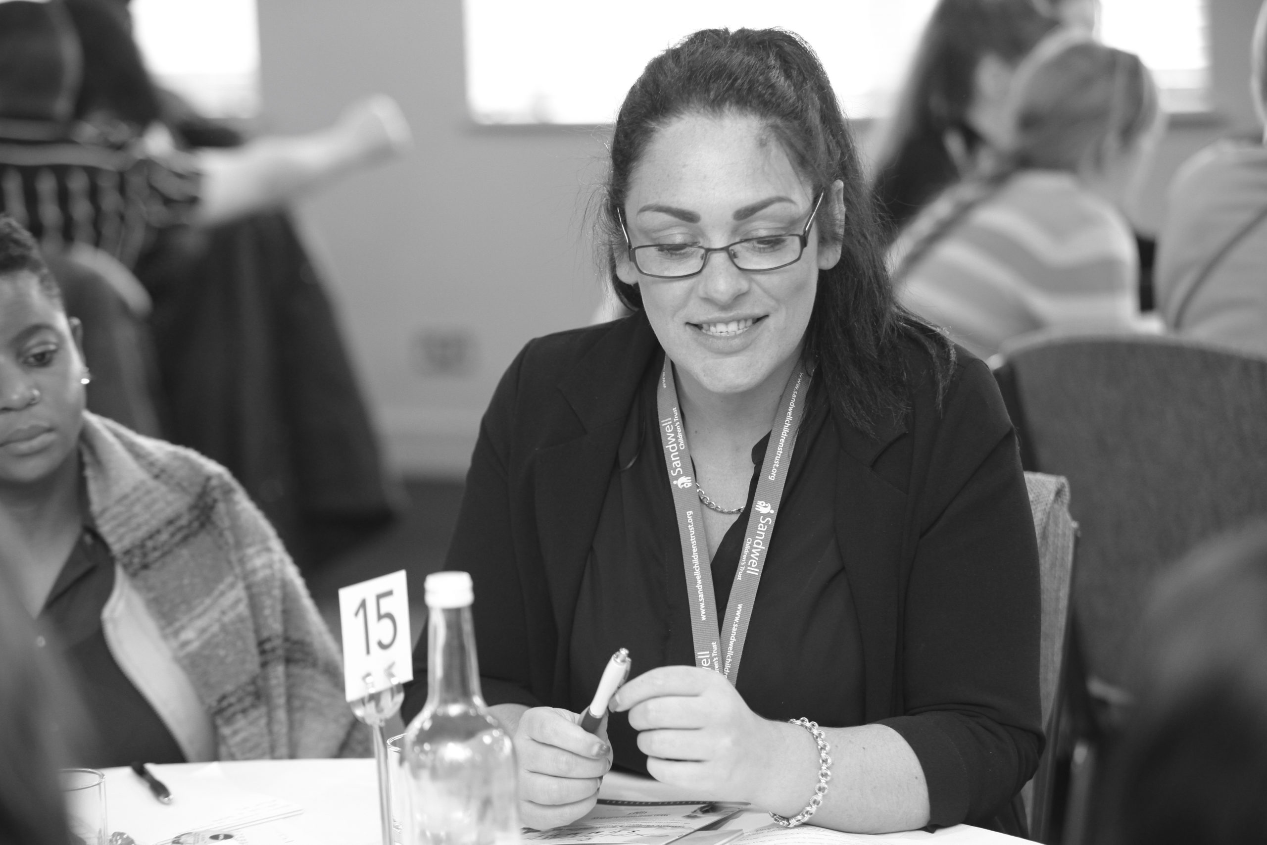A woman smiling at a staff training event